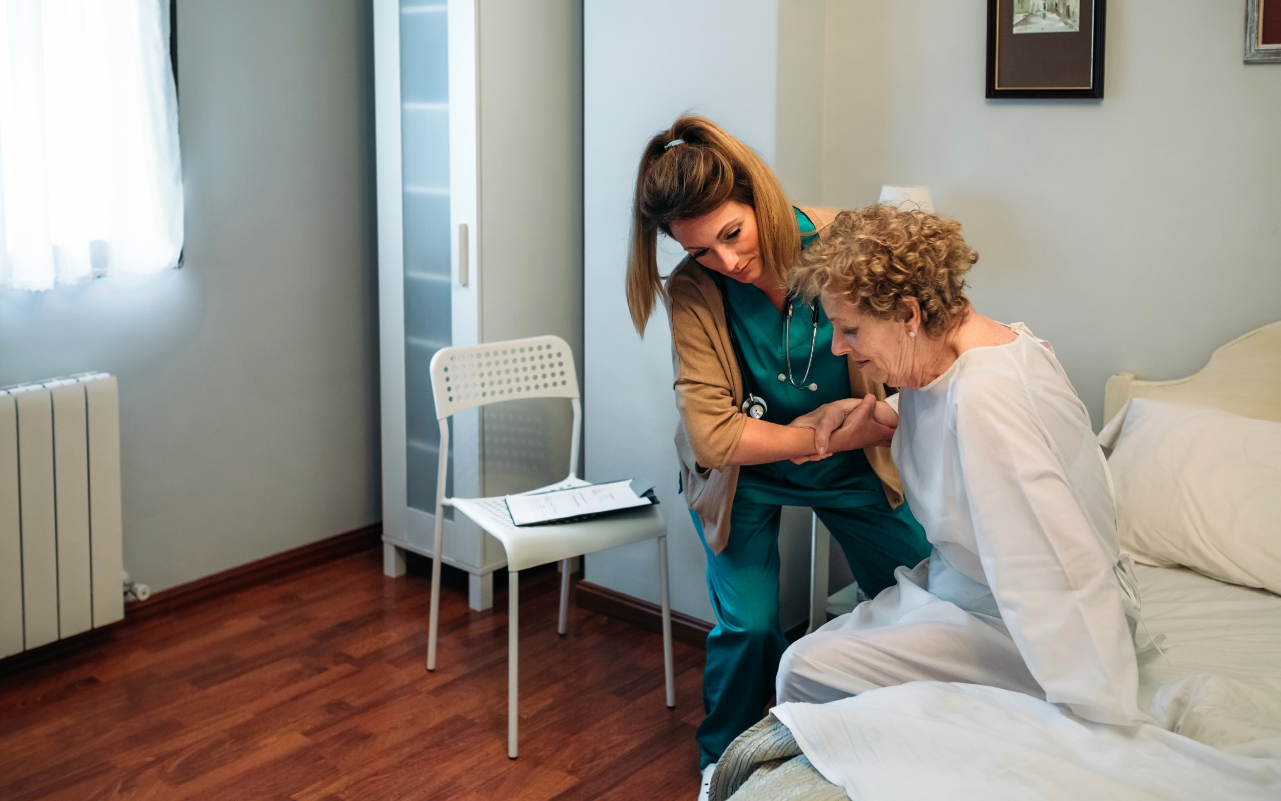 Caregiver helping elderly patient.