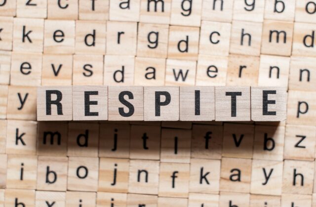 a series of scrabble tiles act as a base, and on top of them the word "respite" is written in more tiles