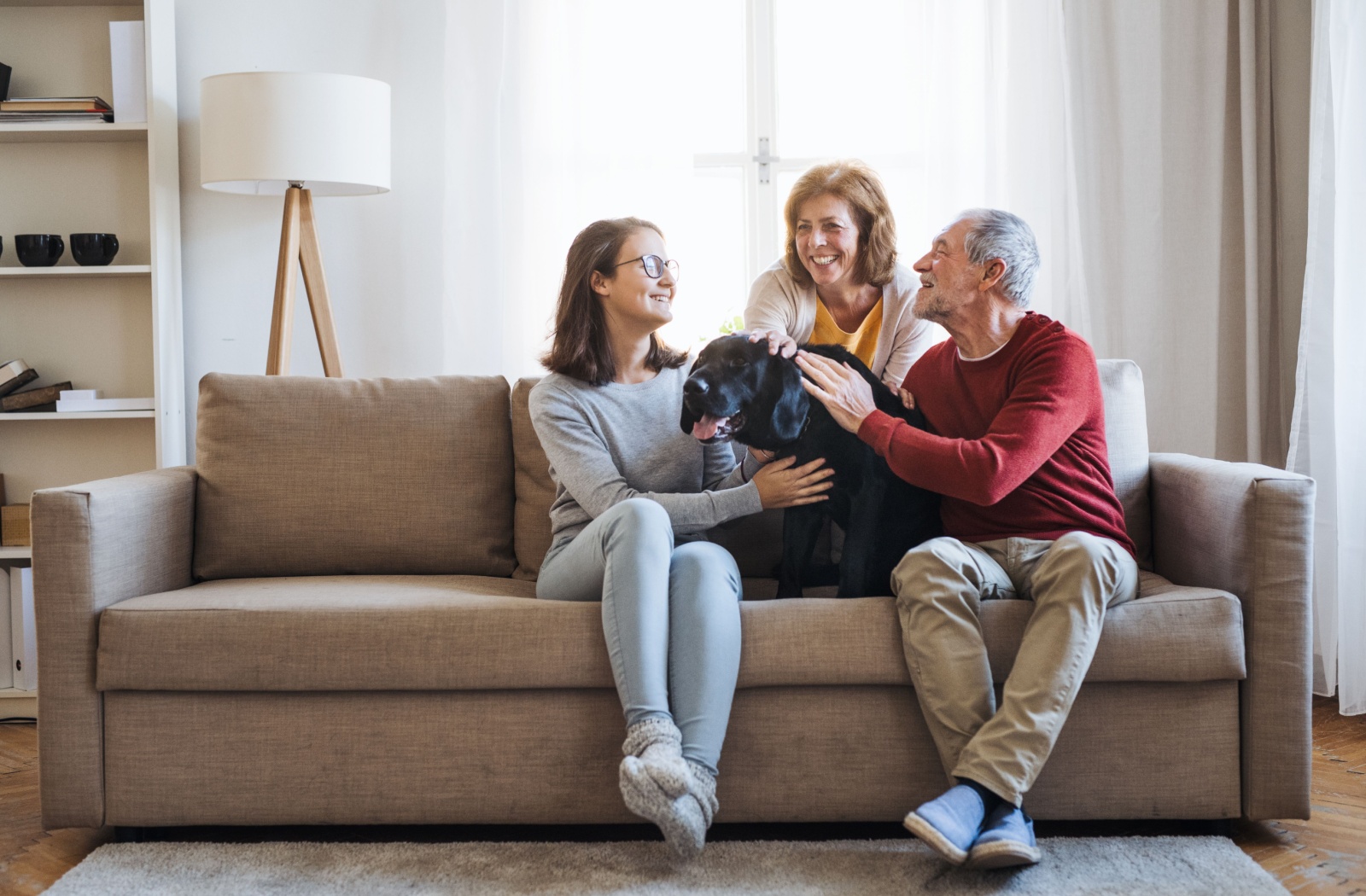 A family and their pet dog spending time together with their loved one in hospice care.